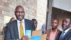 Immigration and Citizen Services PS Julius Bitok holding passports