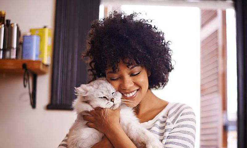 A woman having a good time with a cat