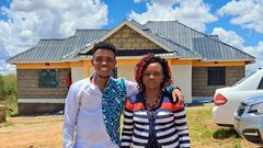 Sammy Kioko and his mother in their newly constructed house
