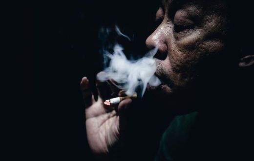 An old man smoking cigarette