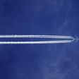 Bottom view of plane with contrail [Credit: SevenStorm JUHASZIMRUS]