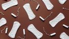 Sanitary towels and tampons on a brown background [Photo: Cliff Booth]