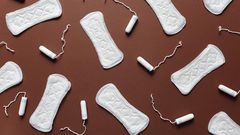 Sanitary towels and tampons on a brown background [Photo: Cliff Booth]