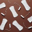 Sanitary towels and tampons on a brown background [Photo: Cliff Booth]
