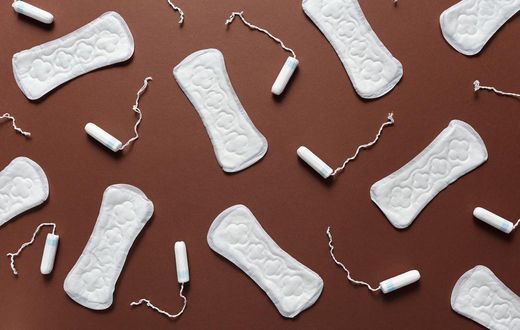 Sanitary towels and tampons on a brown background [Photo: Cliff Booth]