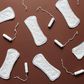 Sanitary towels and tampons on a brown background [Photo: Cliff Booth]
