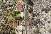 A photo showing a slum neighbouring an affluent estate
