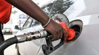 A pump attendant fills the tank of a car at a petrol station in September 4, 2018 in Nairobi as a 16 per cent VAT on petroleum products was decided and fuel distributors refused to collect stocks from depots. (Photo by SIMON MAINA/AFP via Getty Images)