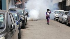 A protestor walks away from teargas during Occupy Parliament protests in Kenya