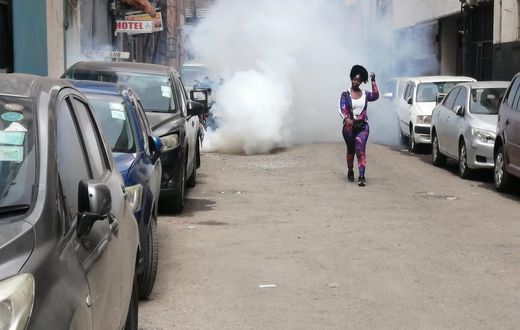 A protestor walks away from teargas during Occupy Parliament protests in Kenya