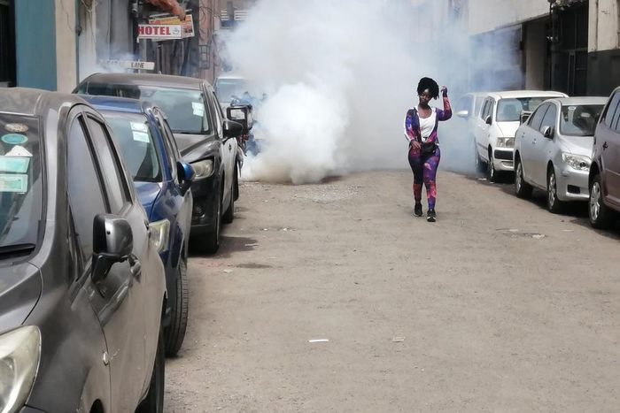 A protestor walks away from teargas during Occupy Parliament protests in Kenya