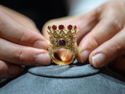 A gold, ruby, and diamond crown ring, designed and worn by the late US rapper Tupac Shakur during his last public appearance in 1996, is displayed during a press preview at Sotheby's in New York City on July 20, 2023.Ed JONES / AFP