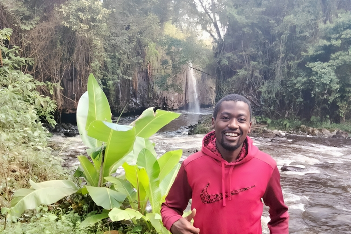 William Maina in a waterfall exploration