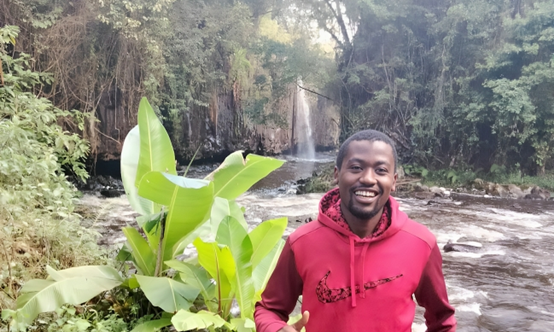 William Maina in a waterfall exploration
