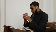 A religious man praying solemnly [Image Credit: Mart Production]