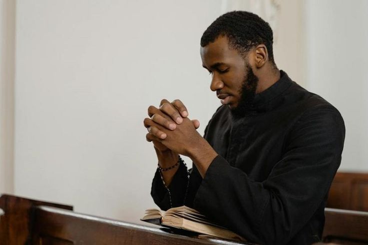 A religious man praying solemnly [Image Credit: Mart Production]