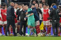 Aaron Ramsdale of Arsenal is led away after a fan tried to engage with him during the Premier League match at the Tottenham Hotspur Stadium on January 15, 2023.