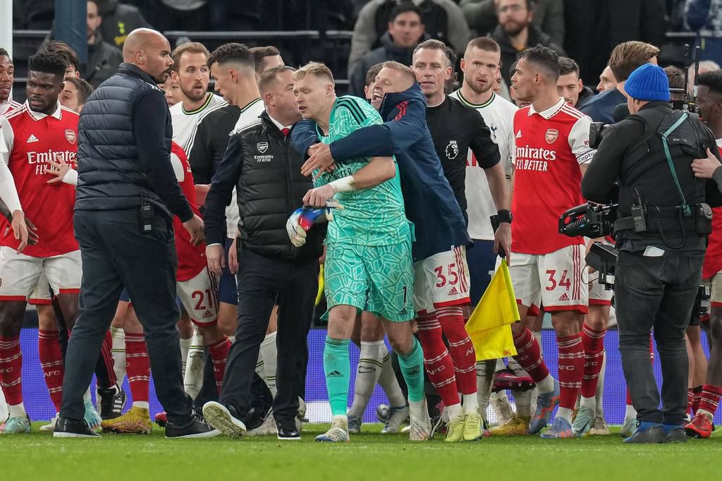 Aaron Ramsdale of Arsenal is led away after a fan tried to engage with him during the Premier League match at the Tottenham Hotspur Stadium on January 15, 2023.