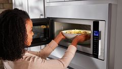 Lady using a microwave