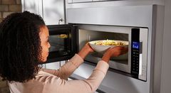 Lady using a microwave
