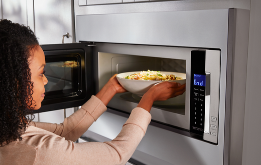 Lady using a microwave