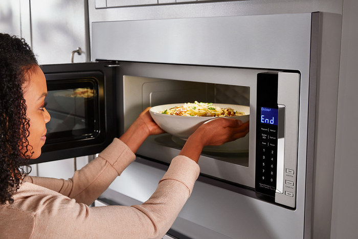 Lady using a microwave