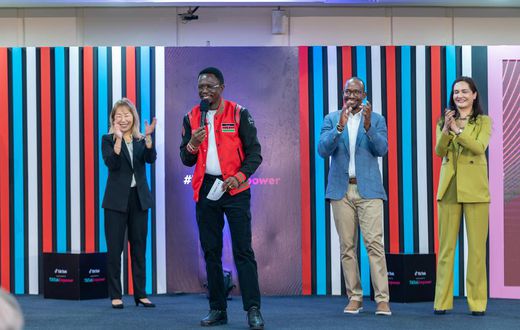 Cabinet Secretary Ministry of Youth Affairs, Creative Economy, and Sports Ababu Namwamba, EGH (centre) addresses the crowd at the launch of #TikTokEmpower with Yunus Social Business. Flanking him is Ara Yoo Han, Global Social Impact Lead at ByteDance /...