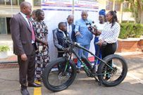 Jairus Kipkogei presented with a special electric bike during his admission to University
