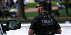 A uniformed Secret Service officer is pictured.