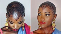 Lupita Nyong'o dorns intricate henna design on her bald head