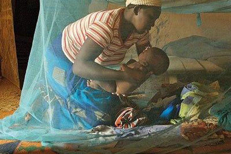 Mother and child inside a mosquito net