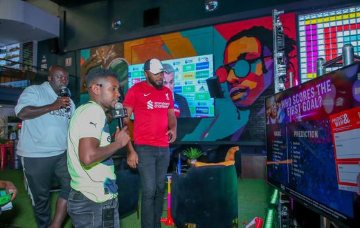 MC Lotan Salapei(left), radio presenter Fred Arocho(center) and MC Eric Njiruanalyzing the predictions on screen during the Guinness brightest matchday madeby the fans at Bar Next Door, Kiambu Road