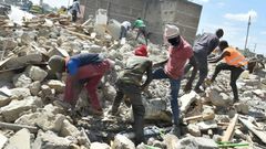 File image of people digging through the rubble to salvage what they can after demolitions in Nairobi