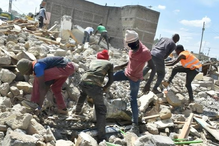 File image of people digging through the rubble to salvage what they can after demolitions in Nairobi