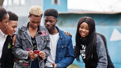 Young people having fun and using technology