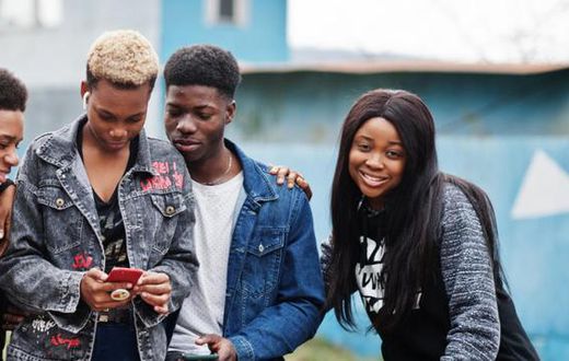 Young people having fun and using technology