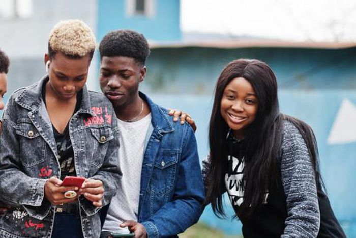 Young people having fun and using technology