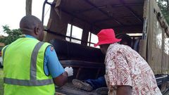 File image of police officers ferrying a dead body.