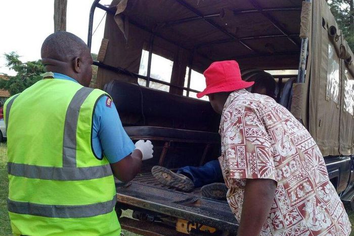 File image of police officers ferrying a dead body.