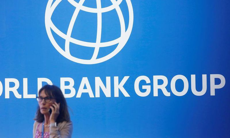FILE PHOTO: A participant stands near a logo of World Bank at the International Monetary Fund - World Bank Annual Meeting 2018 in Nusa DuaReuters