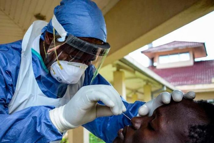 A medical officer takes a sample for the COVID-19 coronavirus at the laboratory of Kenya Medical Research Institute (KEMRI) where they have capacity to test 384 samples per day in Kisumu, western Kenya, on April 23, 2020. - KEMRI (Photo by Brian ONGORO...