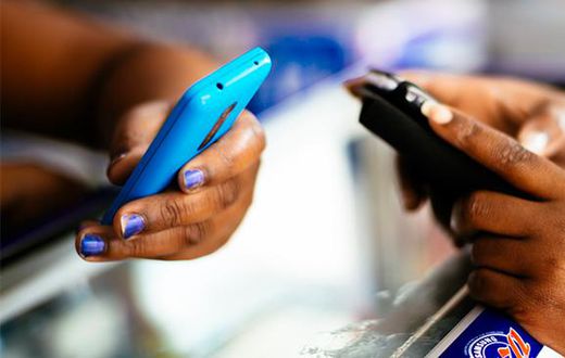 Stock photo of people holding phones