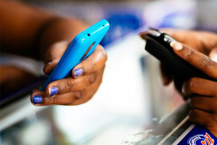 Stock photo of people holding phones