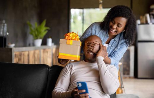A lady surprising his man with a gift