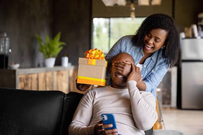 A lady surprising his man with a gift