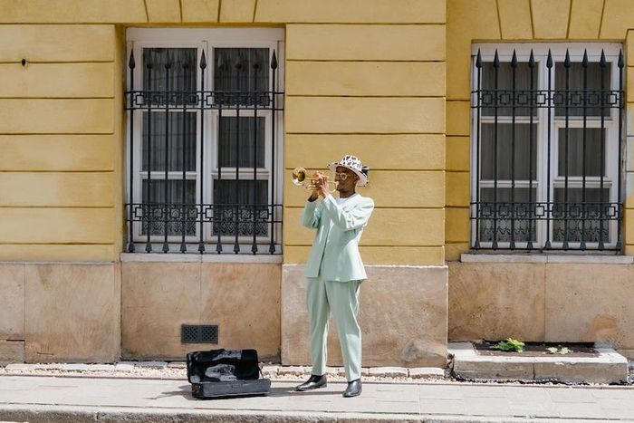 Man playing the trumpet in the street [Image: Mart Production]