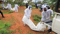Forensic experts and homicide detectives carry the bodies of suspected members of Good News International Church after their remains were exhumed from graves in Shakahola forest Kilifi County on April 22, 2023. [Photo: Reuters]