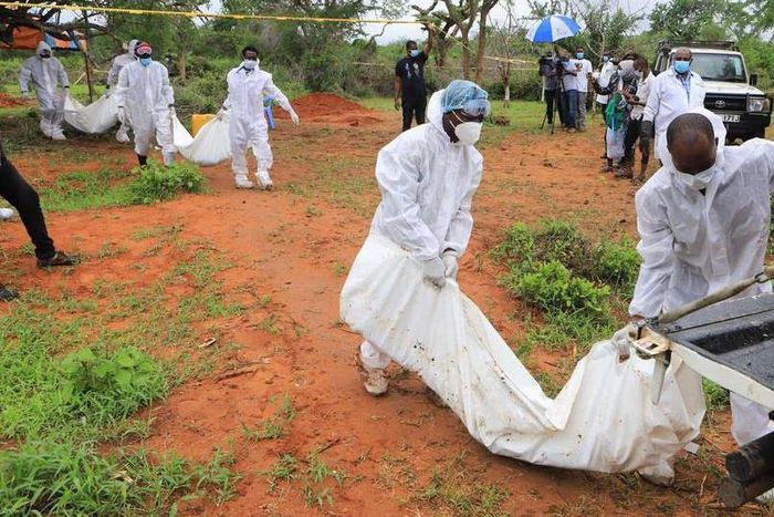 Forensic experts and homicide detectives carry the bodies of suspected members of Good News International Church after their remains were exhumed from graves in Shakahola forest Kilifi County on April 22, 2023. [Photo: Reuters]