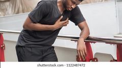 A stock photo of someone posing like they suffered a heart attack
