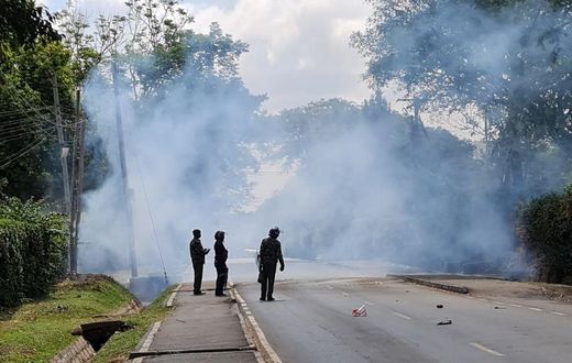 Police look on after launching tear gas